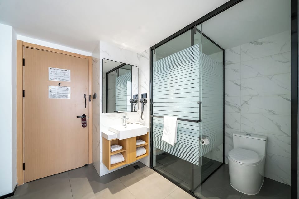 Basic Twin Room | Bathroom | Shower, hair dryer, slippers, towels