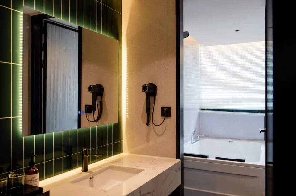 Elite Studio Suite | Bathroom | Rainfall showerhead, hair dryer, slippers, towels