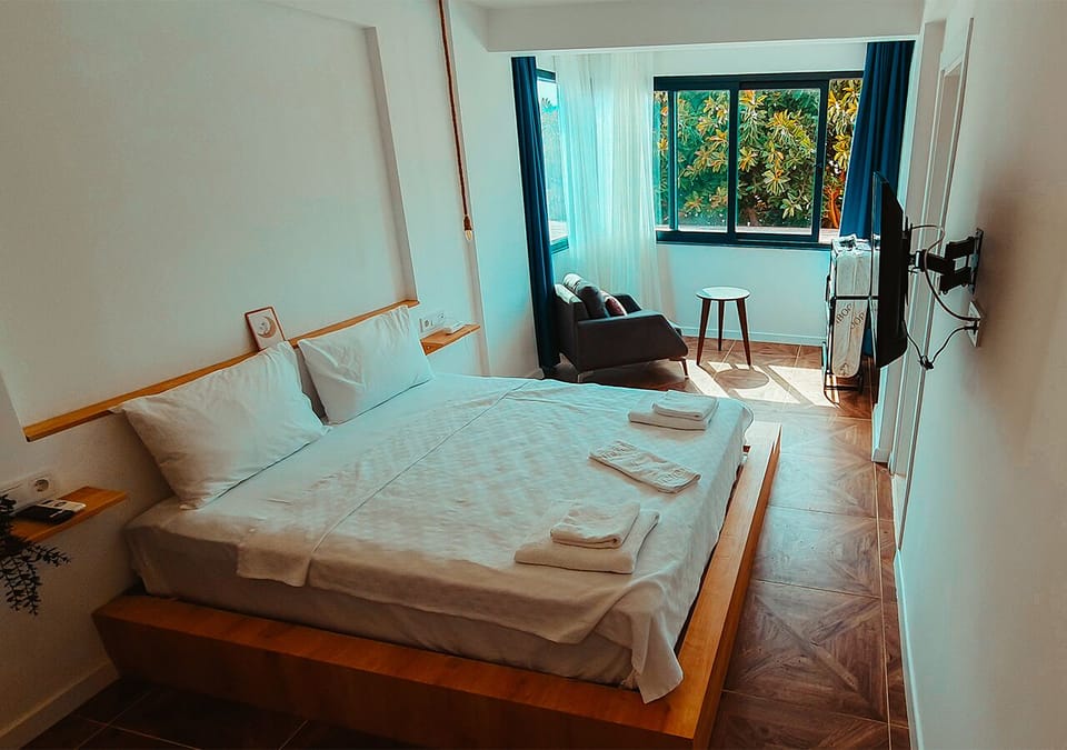 Classic Triple Room, Partial Sea View | In-room safe, blackout drapes, free WiFi, bed sheets
