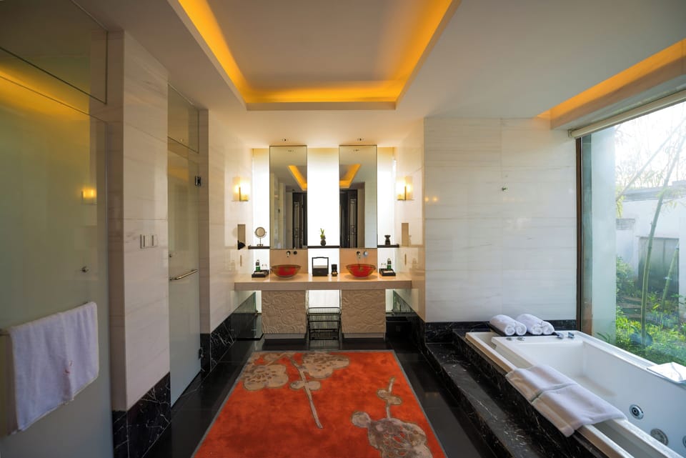Separate tub and shower, hair dryer, slippers, towels