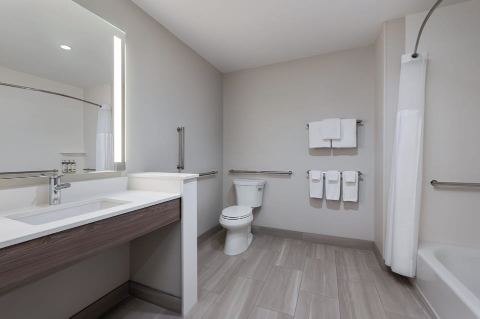 Desk, laptop workspace, blackout drapes, iron/ironing board