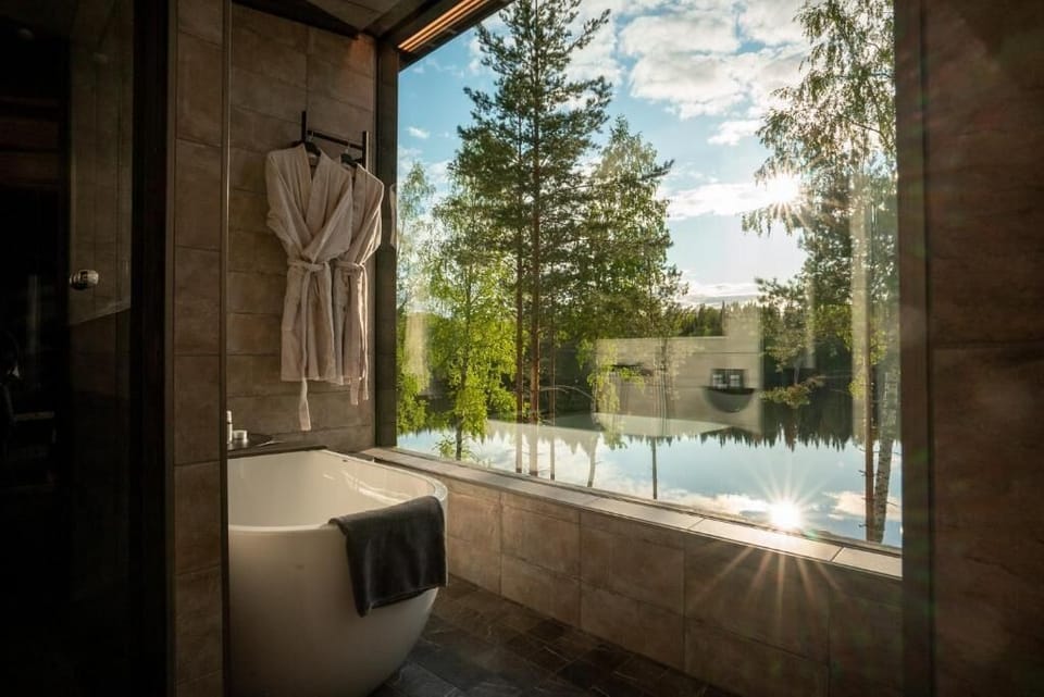 Suite, Balcony, Lake View | Bathroom | Separate tub and shower, free toiletries, hair dryer, towels