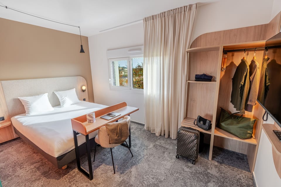 Premium bedding, desk, laptop workspace, blackout drapes