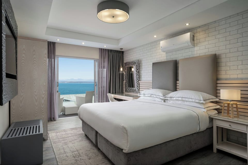Room, 1 King Bed, Balcony, Harbor View | Down comforters, in-room safe, individually decorated