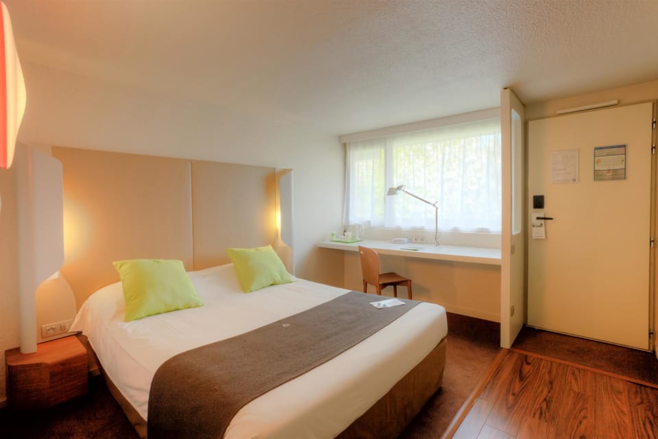 Premium bedding, desk, laptop workspace, blackout drapes