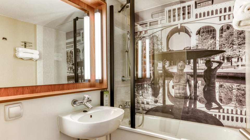 Bathtub, eco-friendly toiletries, hair dryer, towels