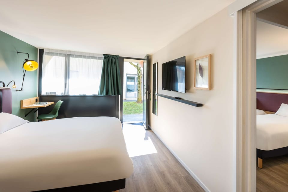 Premium bedding, desk, laptop workspace, blackout drapes