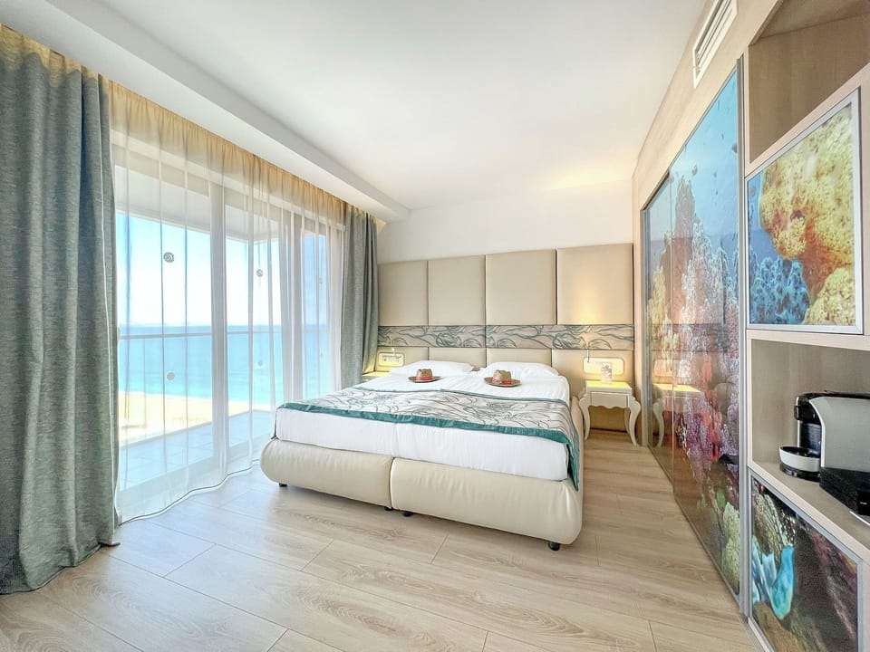 Junior Suite, Side Sea View (Free Beach Access, Safe, Minibar) | Free minibar, in-room safe, desk, bed sheets