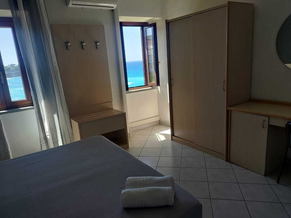 Deluxe Room, Sea View | Minibar, in-room safe, desk, laptop workspace