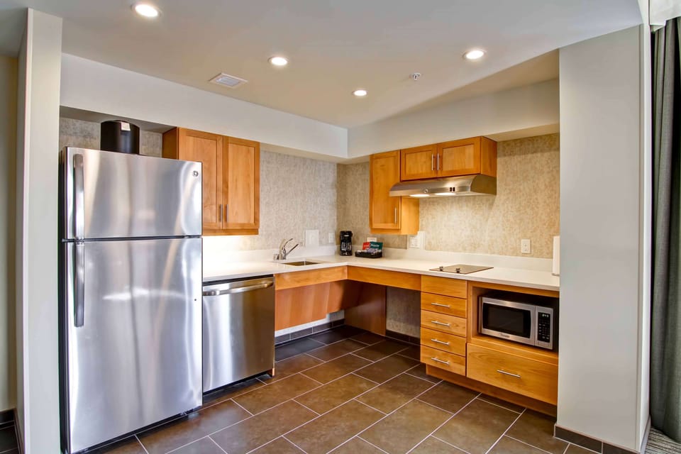 Fridge, microwave, coffee/tea maker, cookware/dishes/utensils