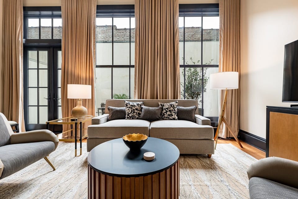 3BR Group Haven + Private Patio Walk to French Qtr | The Mayfair | Living area | 65-inch Smart TV with cable channels, Netflix, Hulu