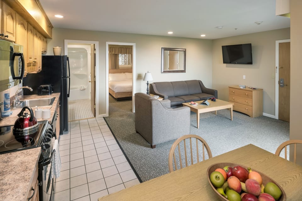 1 Bedroom East Suite | Living area | 35-inch flat-screen TV with cable channels, TV