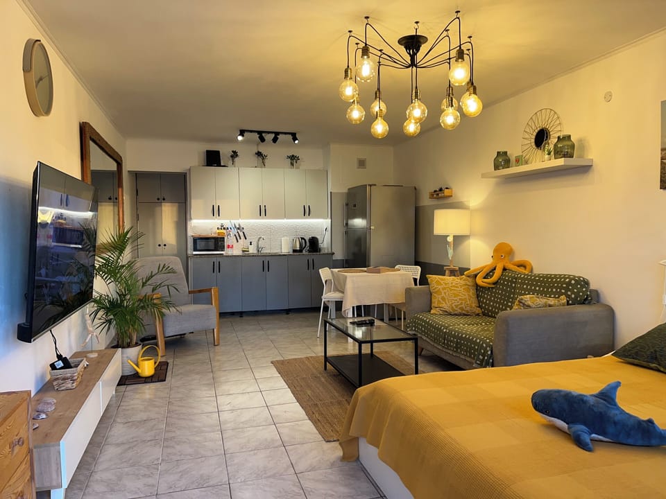 Romantic Studio, 1 Double Bed, Sea View, Poolside | Living area | 65-inch LED TV with digital channels