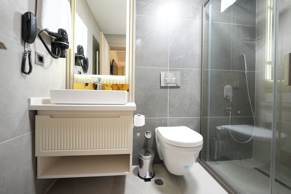 Shower, hair dryer, slippers, towels