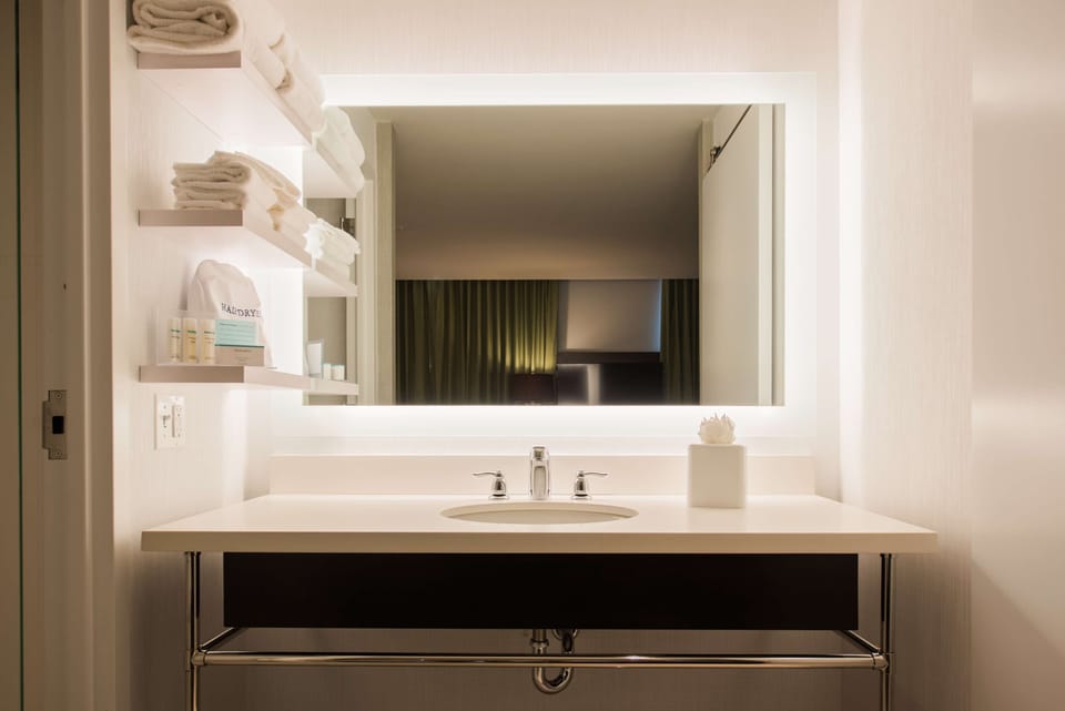 Shower, designer toiletries, hair dryer, towels