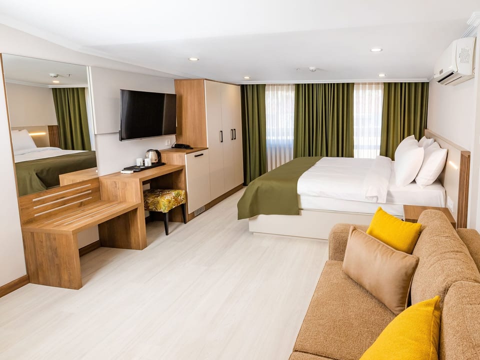 Family Quadruple Room, Balcony, City View | Minibar, in-room safe, soundproofing, iron/ironing board