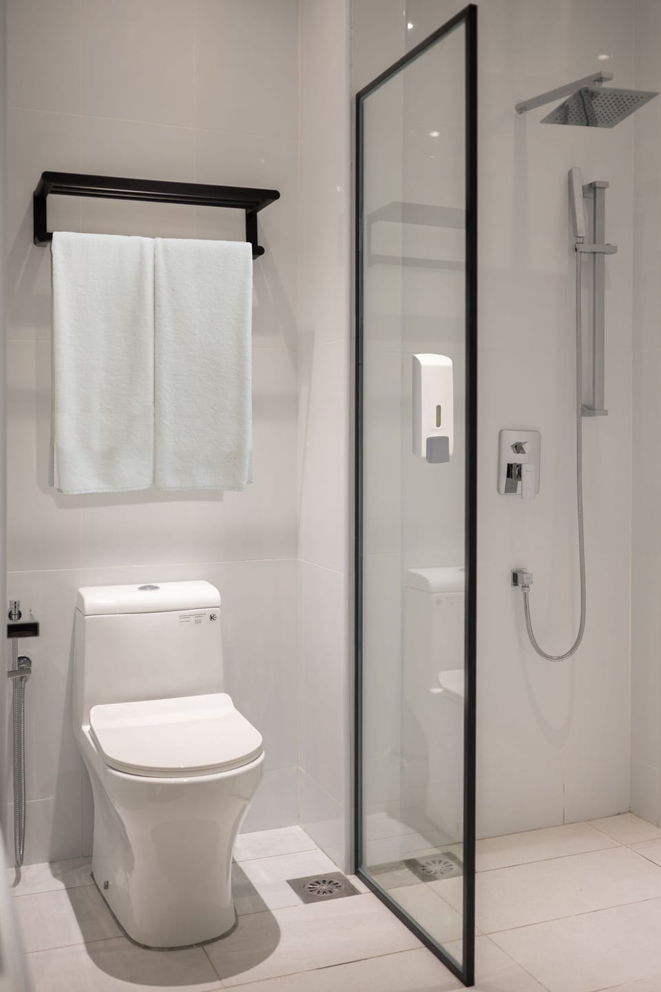 Shower, hair dryer, slippers, towels