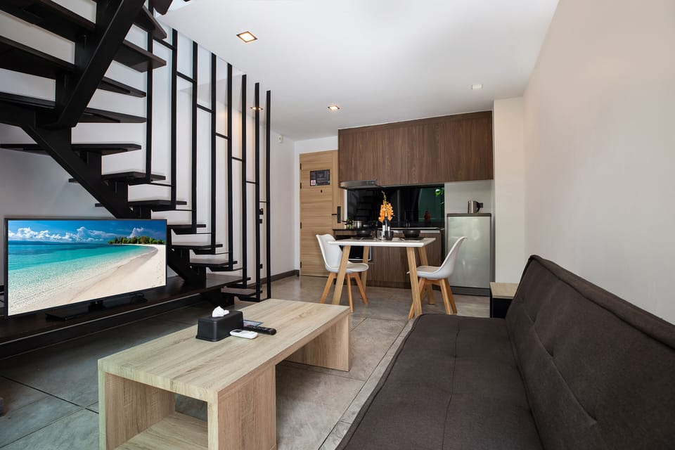 Design Condo, 1 Bedroom, Balcony | Living area | 36-inch flat-screen TV with cable channels