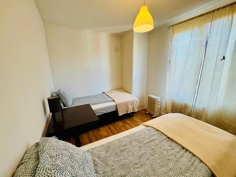 Desk, laptop workspace, bed sheets