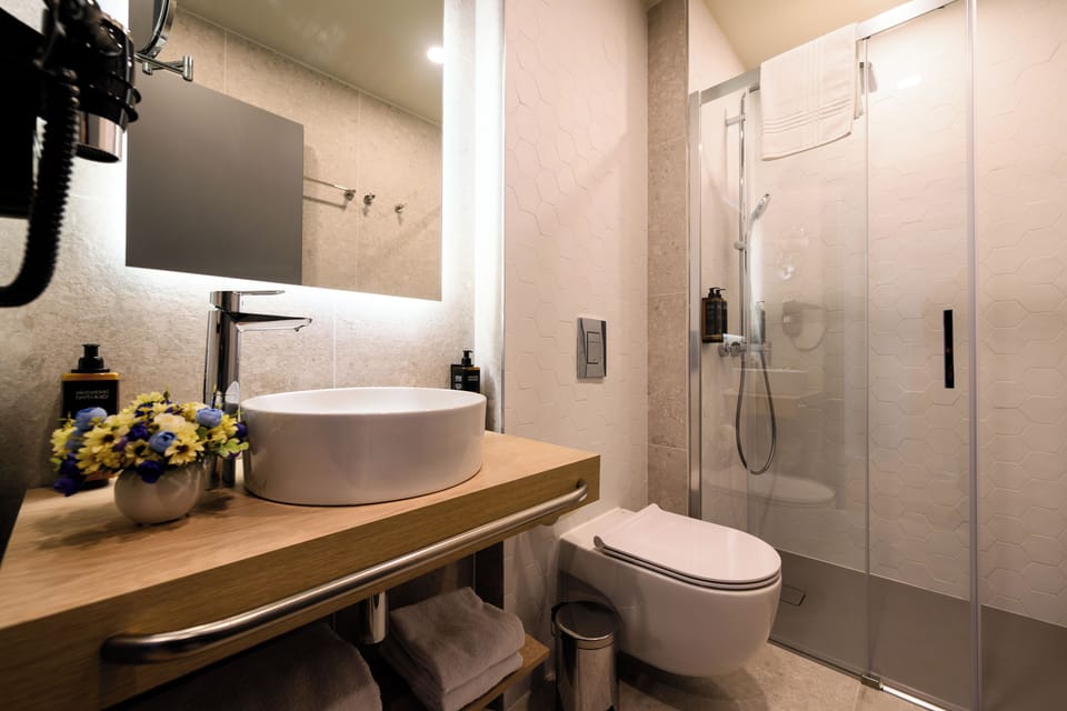 Suite (2 King Beds and 1 Sofa Bed) | Bathroom | Shower, hair dryer, bathrobes, slippers