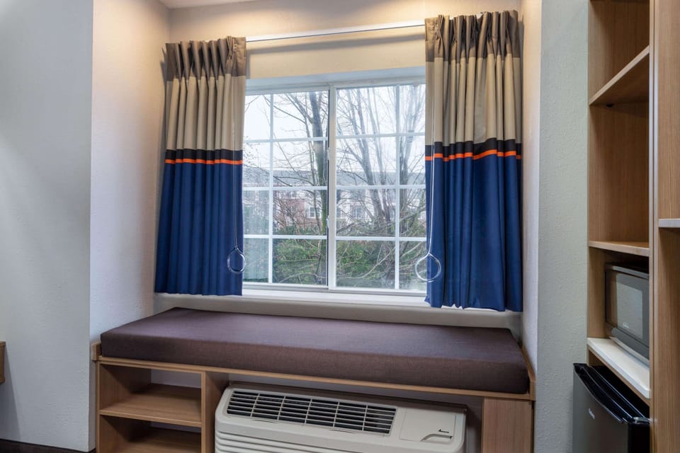 Desk, laptop workspace, blackout drapes, iron/ironing board