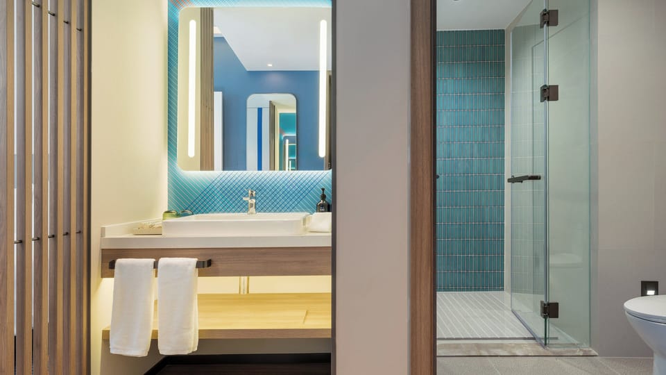 Shower, hair dryer, slippers, towels