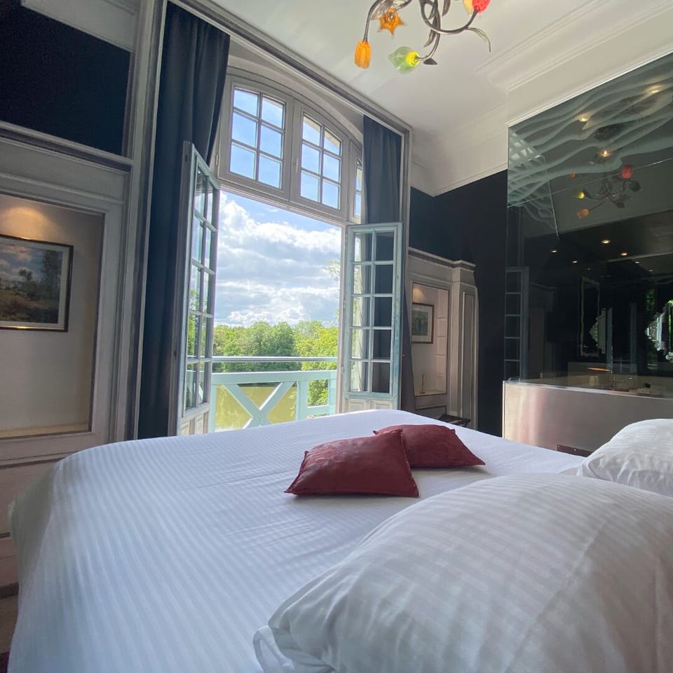 Junior Suite, River View | Minibar, in-room safe, desk, iron/ironing board