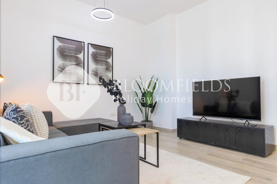 Deluxe Apartment, Balcony, City View | Living area | TV