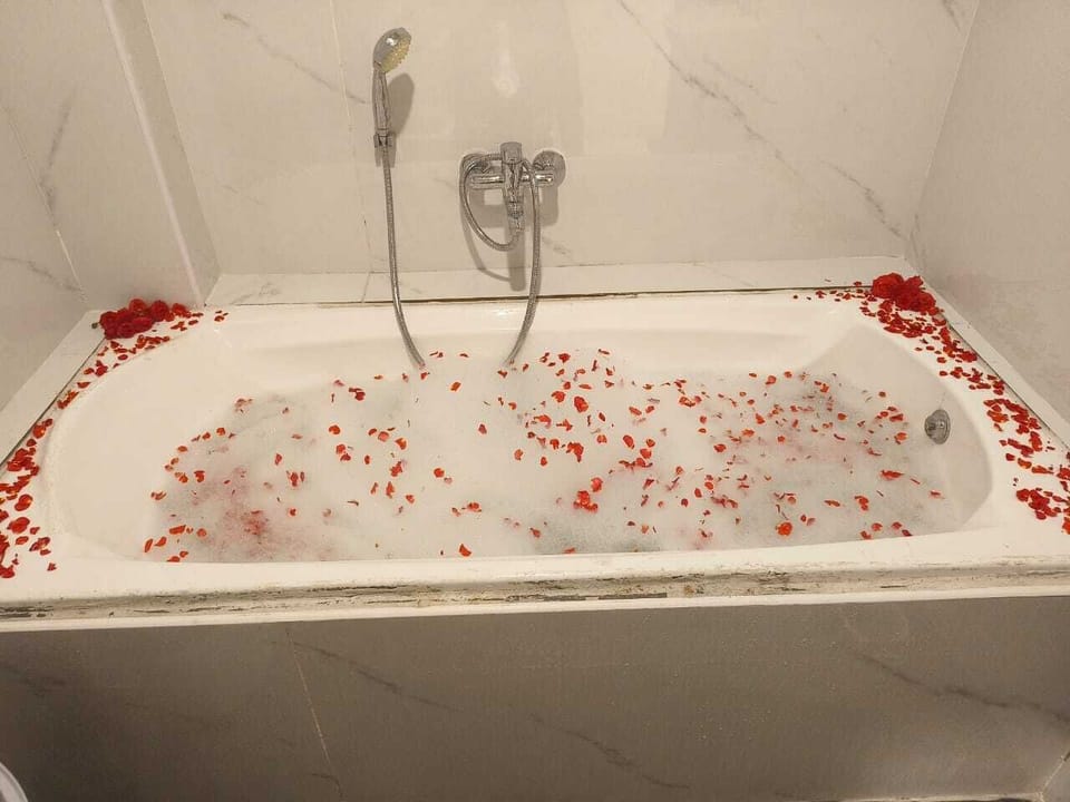 Separate tub and shower, slippers, towels, soap