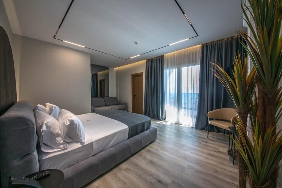 Junior Suite, Balcony, Sea View | Minibar, in-room safe, desk, blackout drapes