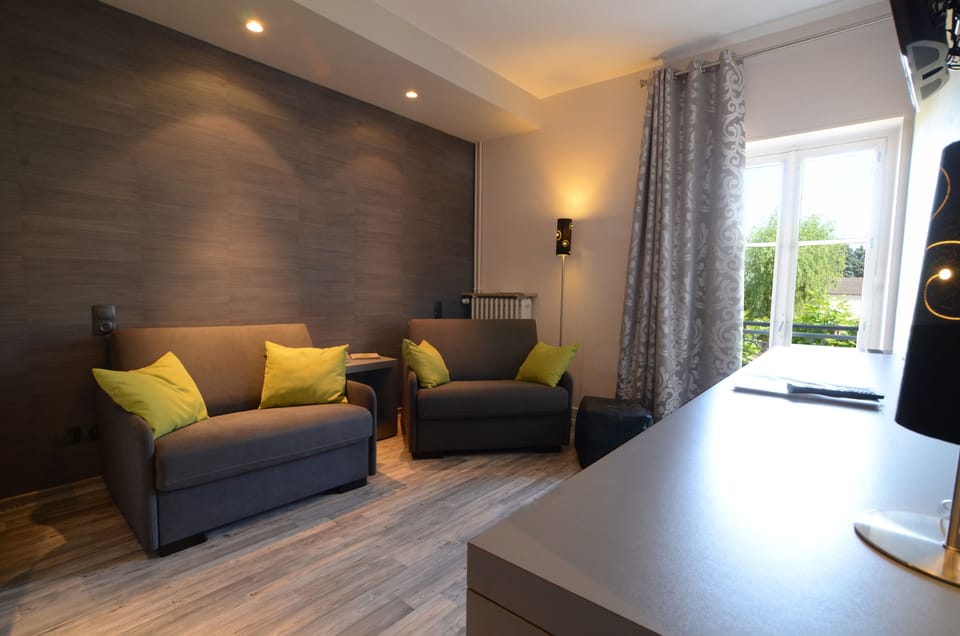 Family Triple Room | Living area | 108-cm flat-screen TV with digital channels, TV