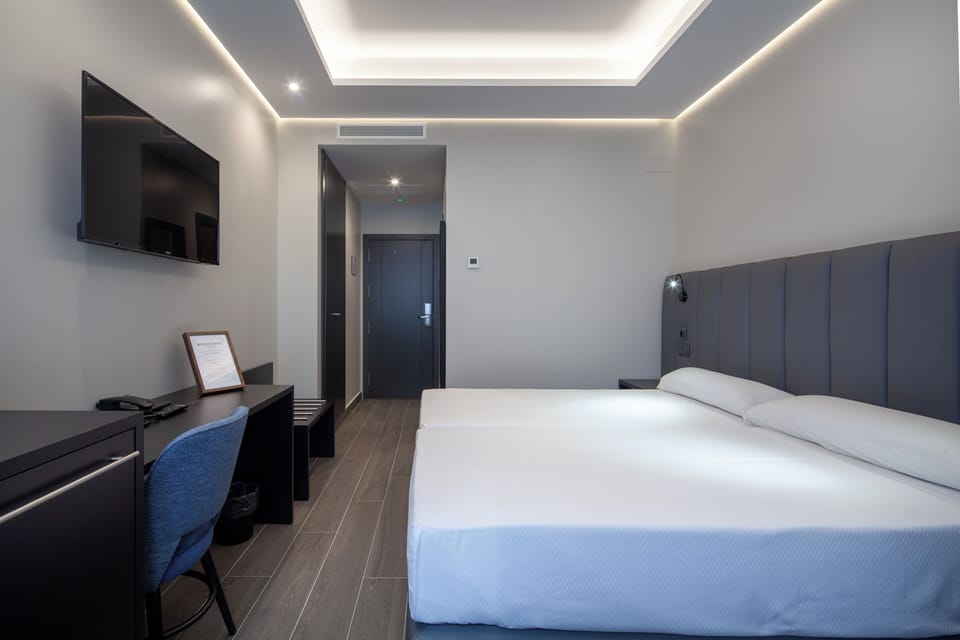 Double Room, Courtyard View | Minibar, in-room safe, desk, laptop workspace