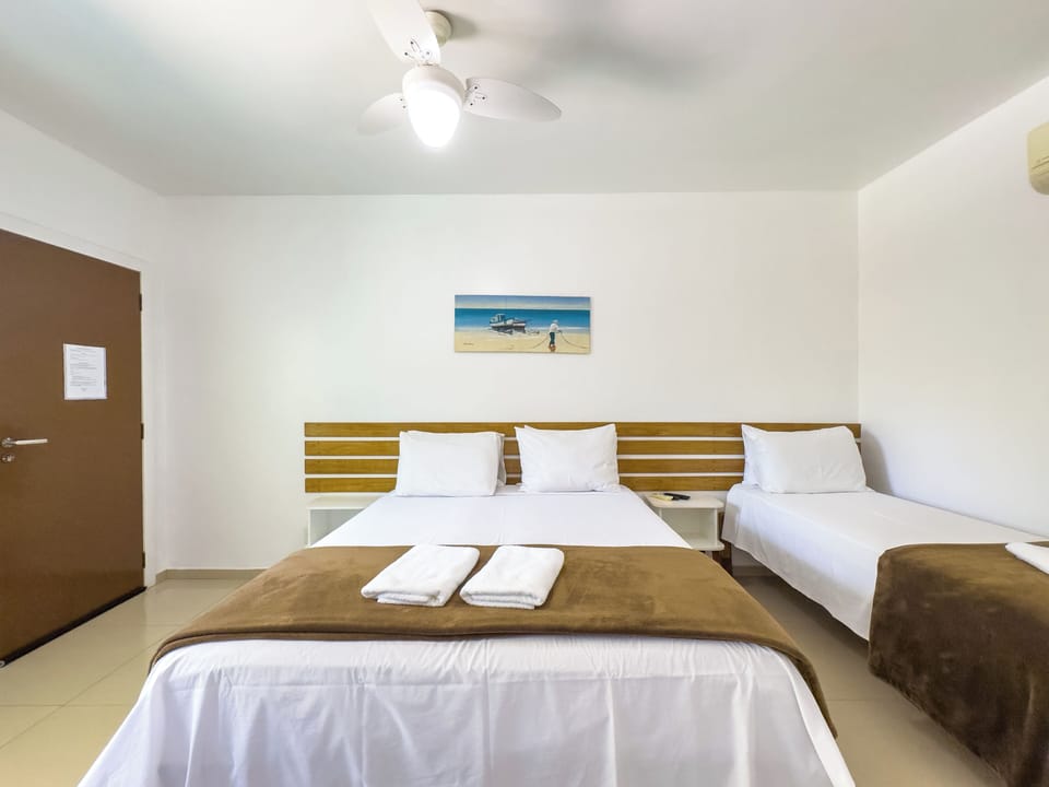 Standard Triple Room | Minibar, blackout drapes, bed sheets