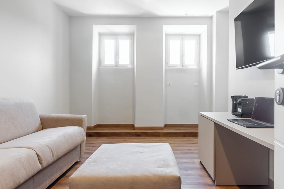 Deluxe Suite, Balcony, City View | Living room | 55-inch Smart TV with digital channels, Netflix, streaming services