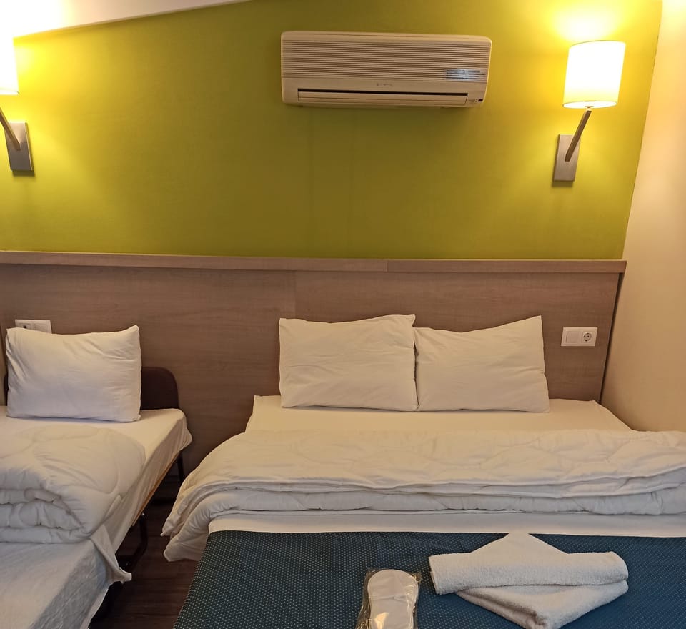 Standard Triple Room, Garden View | Blackout drapes, bed sheets
