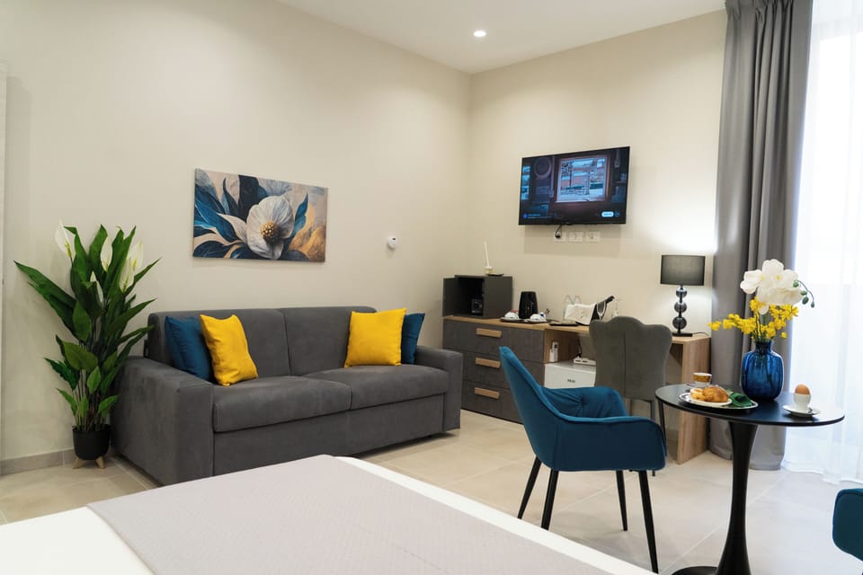 Deluxe Triple Room, Balcony, City View | In-room safe, desk, laptop workspace, blackout drapes