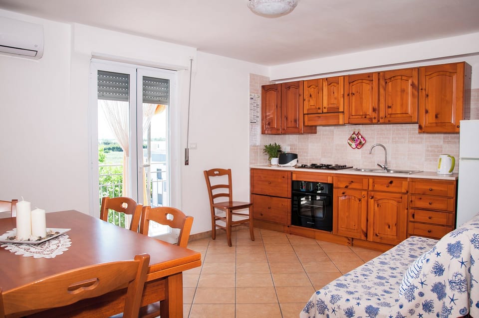 Deluxe Apartment, City View | Private kitchen | Full-size fridge, oven, stovetop, electric kettle