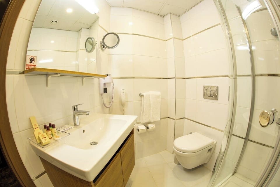 Shower, hair dryer, slippers, towels