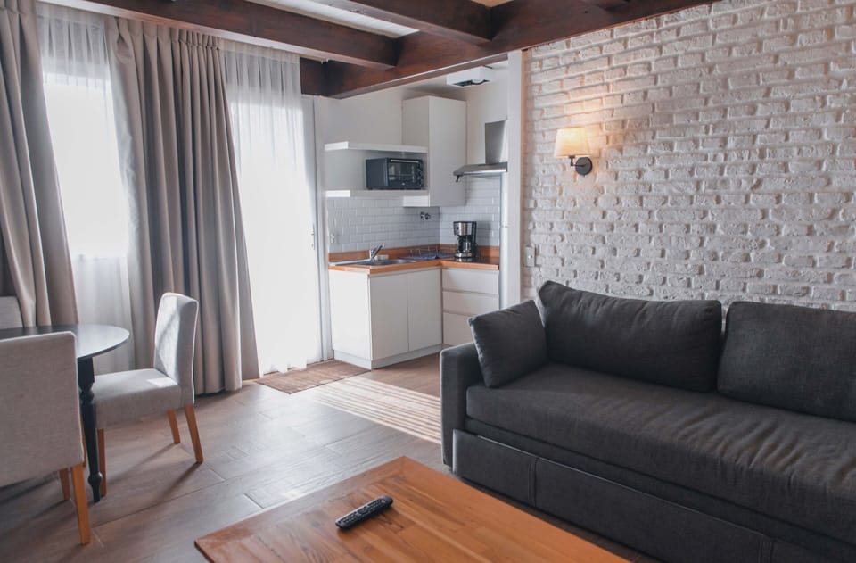 Apartment, Lake View | Living area | TV, fireplace