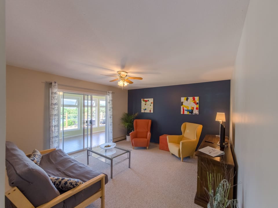 Deluxe Suite, 2 Bedrooms, Garden View | Living area | Flat-screen TV