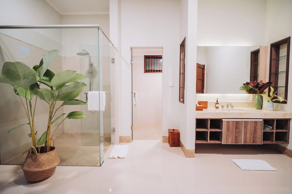 Griya Agung | Bathroom | Separate tub and shower, slippers, soap, shampoo