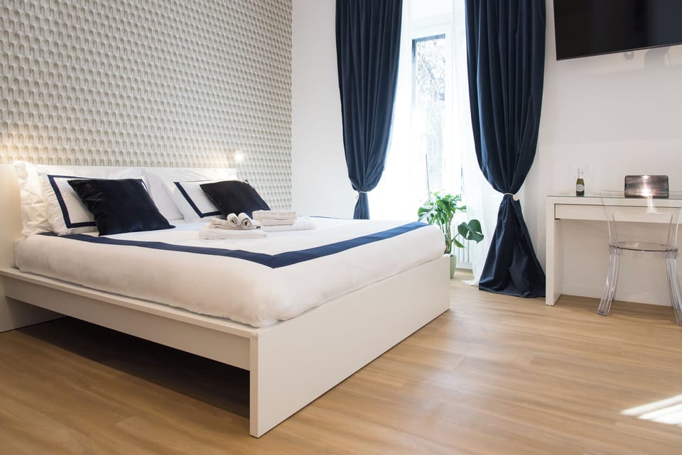 Deluxe Quadruple Room, City View | Desk, laptop workspace, blackout drapes, soundproofing