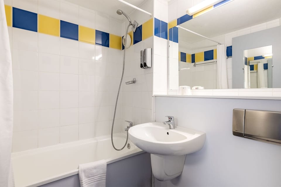 Bathtub, eco-friendly toiletries, hair dryer, towels