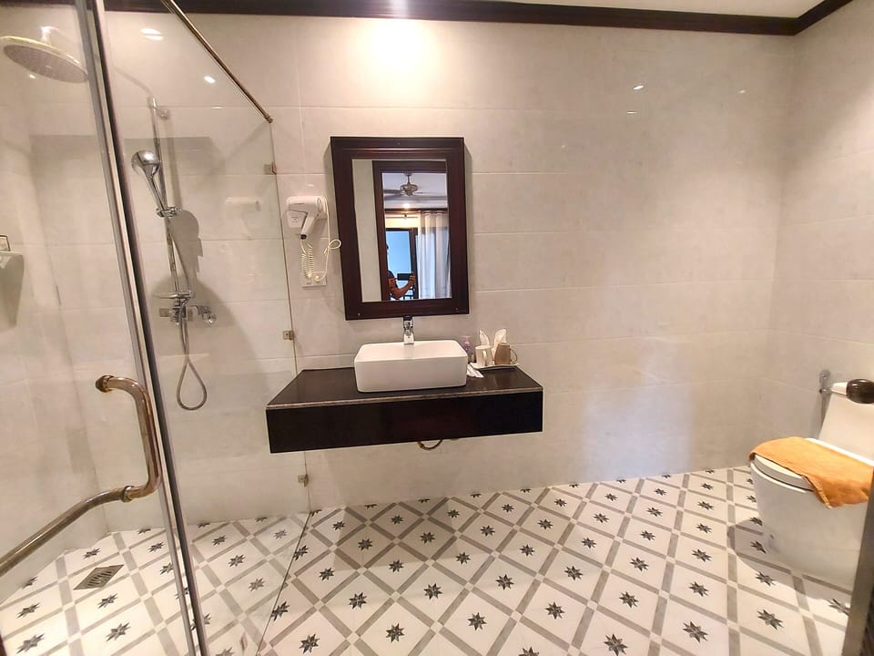 Rainfall showerhead, designer toiletries, hair dryer, slippers