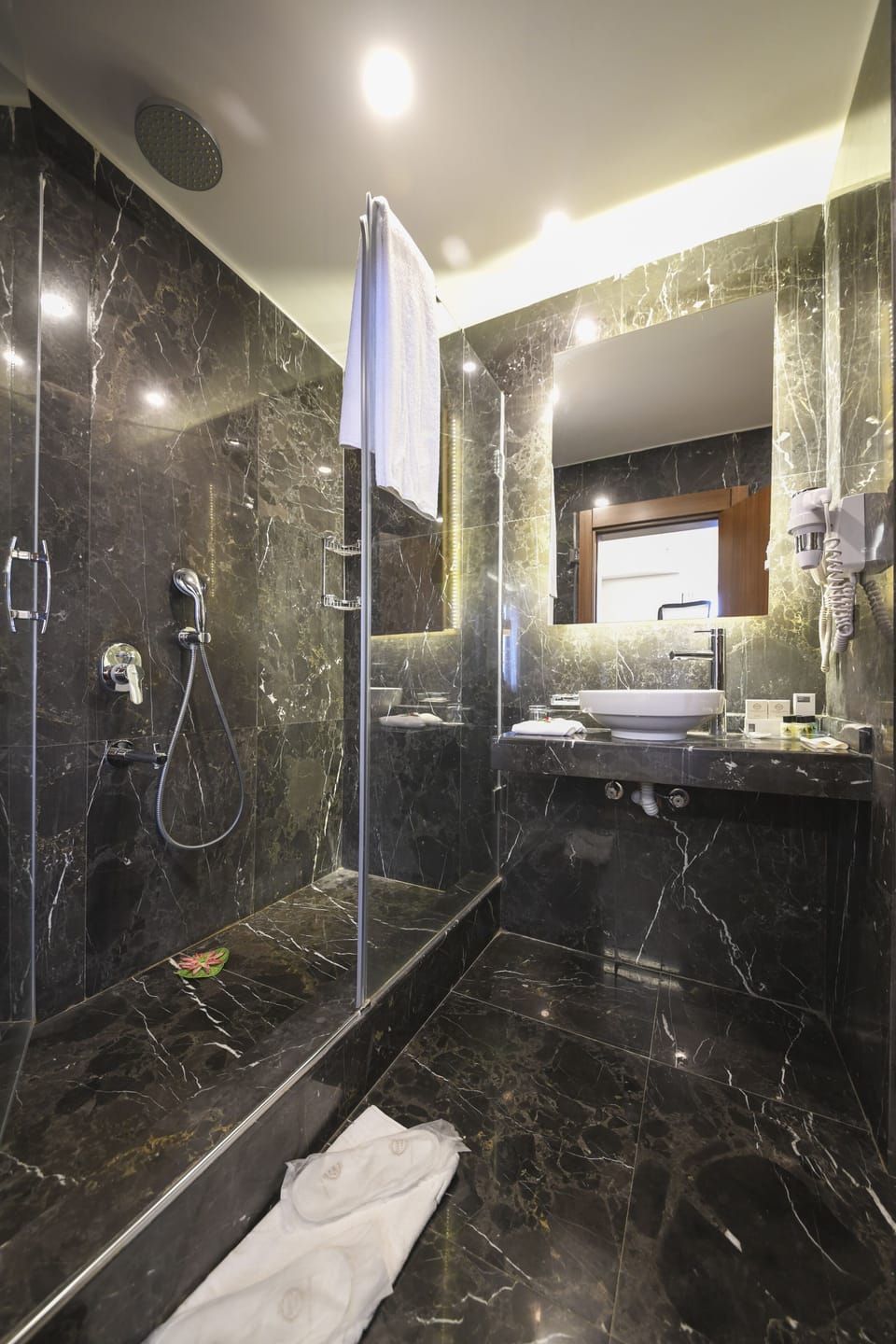 Shower, hair dryer, slippers, towels