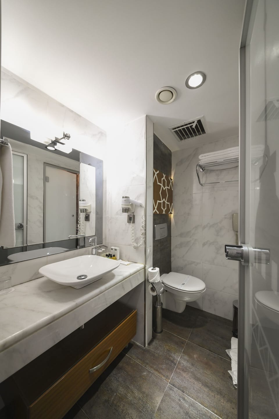 Shower, hair dryer, slippers, towels