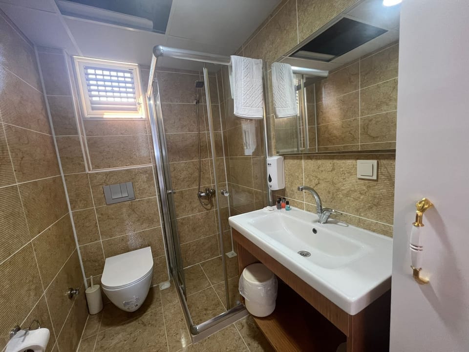 Economy Studio Suite, Sea View | Bathroom | Shower, hair dryer, towels, soap