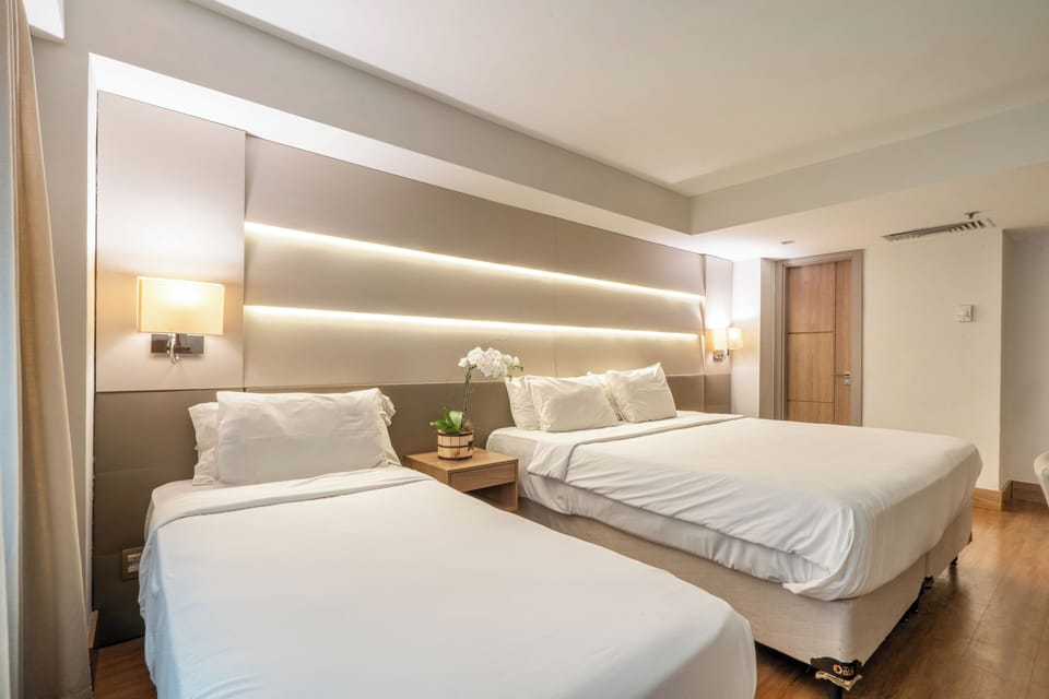 Superior Triple Room | Minibar, in-room safe, desk, blackout drapes