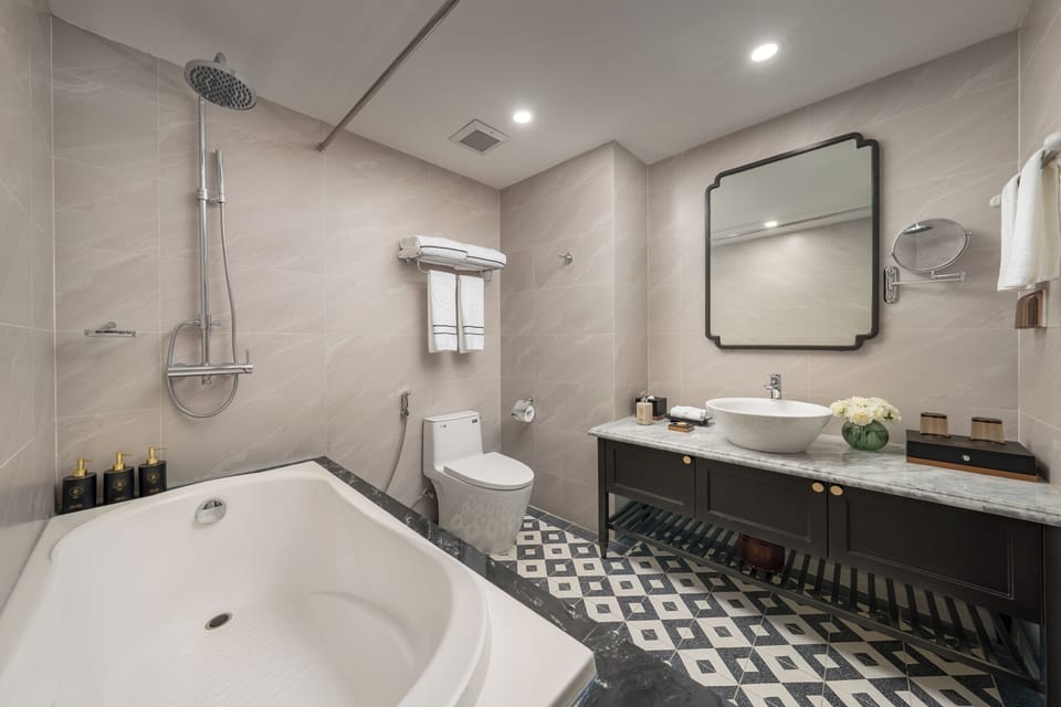 King Suite | Bathroom | Designer toiletries, hair dryer, bathrobes, slippers