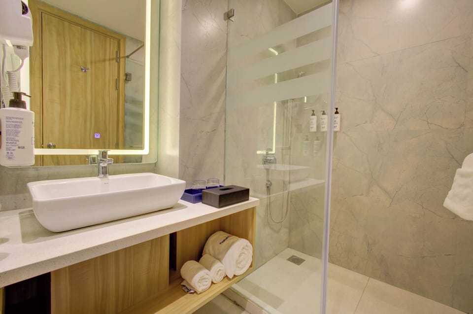 Club Room | Bathroom | Shower, hair dryer, slippers, soap